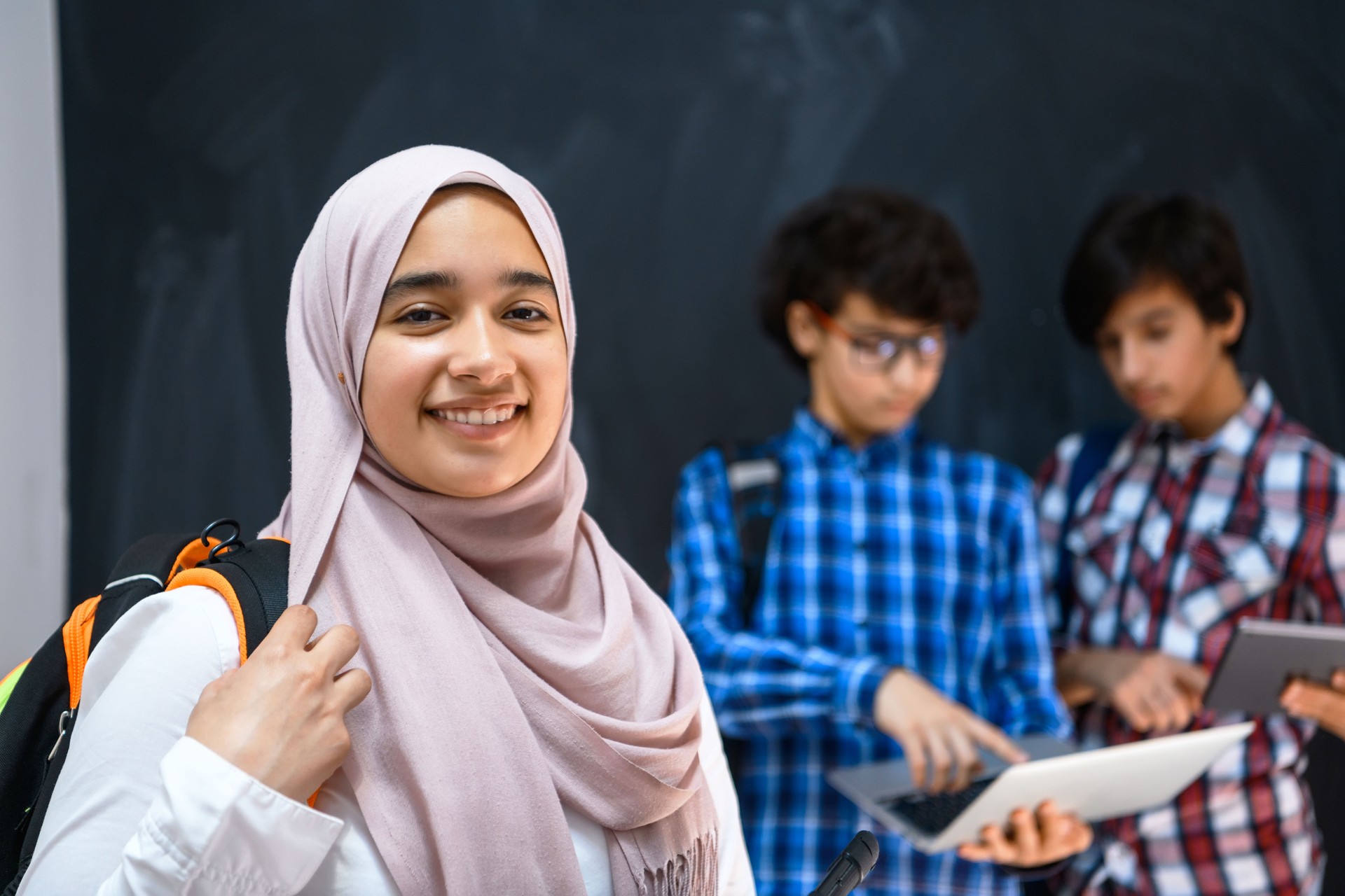 Arabic teenagers team, students group working together on laptop and tablet computer online classroom education concept