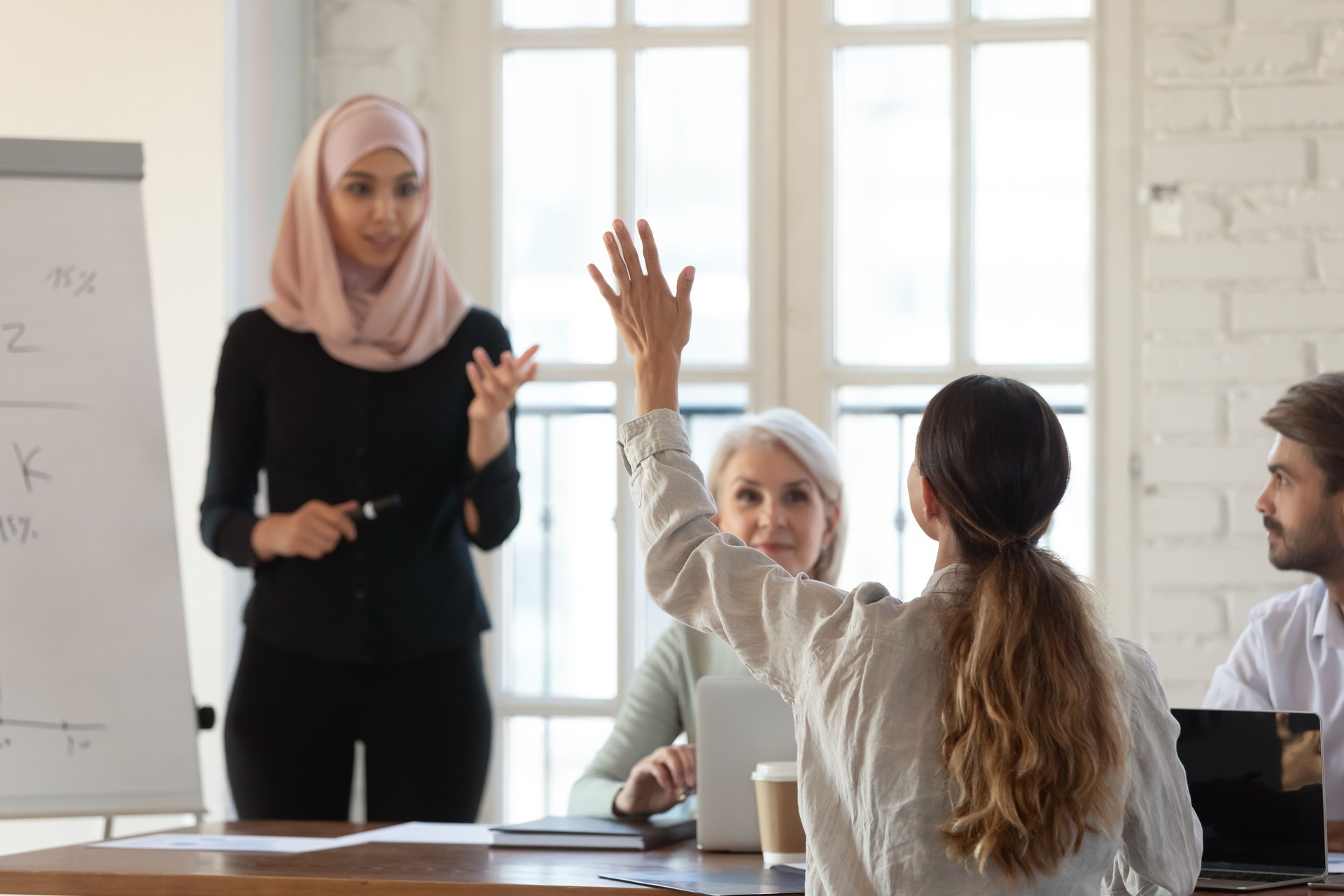 Participant raise hand want ask question to coach at seminar